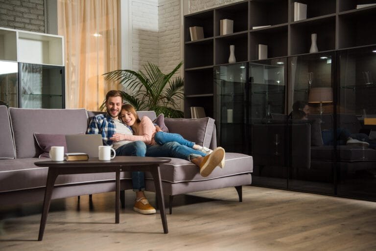 Couple relaxing on the couch in their living room in Pearland, TX