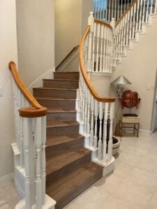 Natural wood stairs in a well-lit space.
