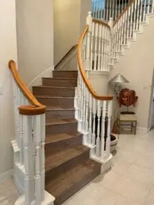 Natural wood stairs in a well-lit space.