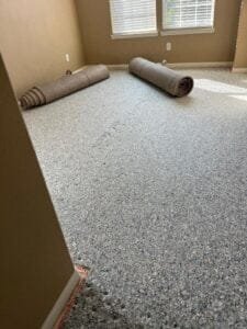 Carpet being laid with care and precision.