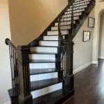 Richly stained solid wood treads on stairs.