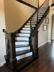 Richly stained solid wood treads on stairs.
