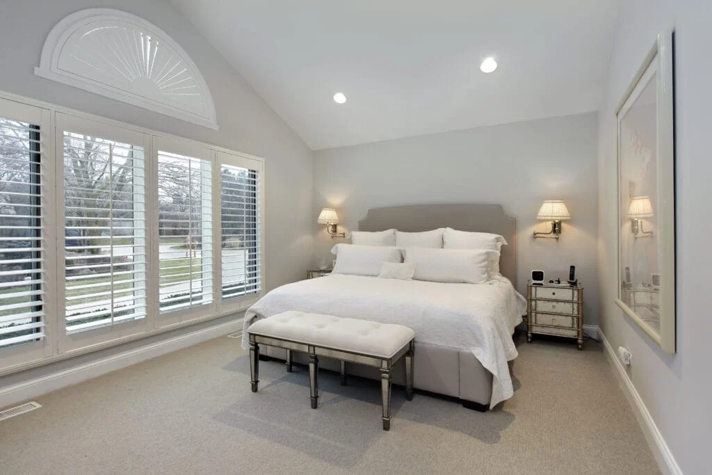 Stunning master bedroom with large open windows and soft cozy carpet
