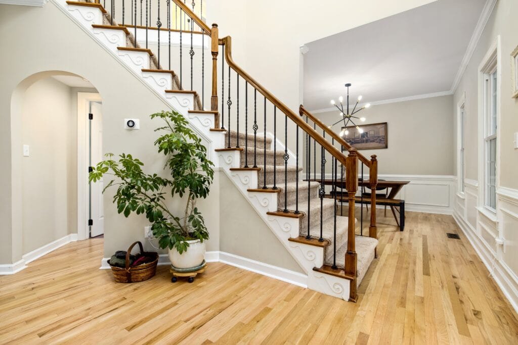 Large Iron Banister Selection in Pearland, TX Classic home entryway with beautiful houseplants and iron banisters on the staircase